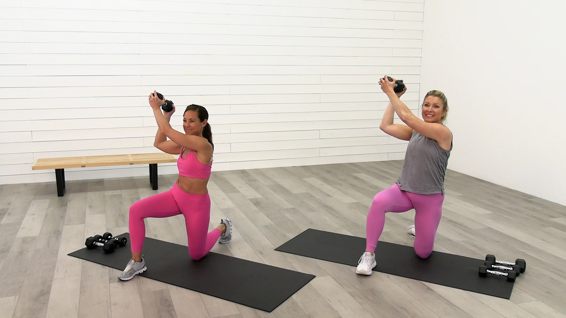 two women exercising with dumbells