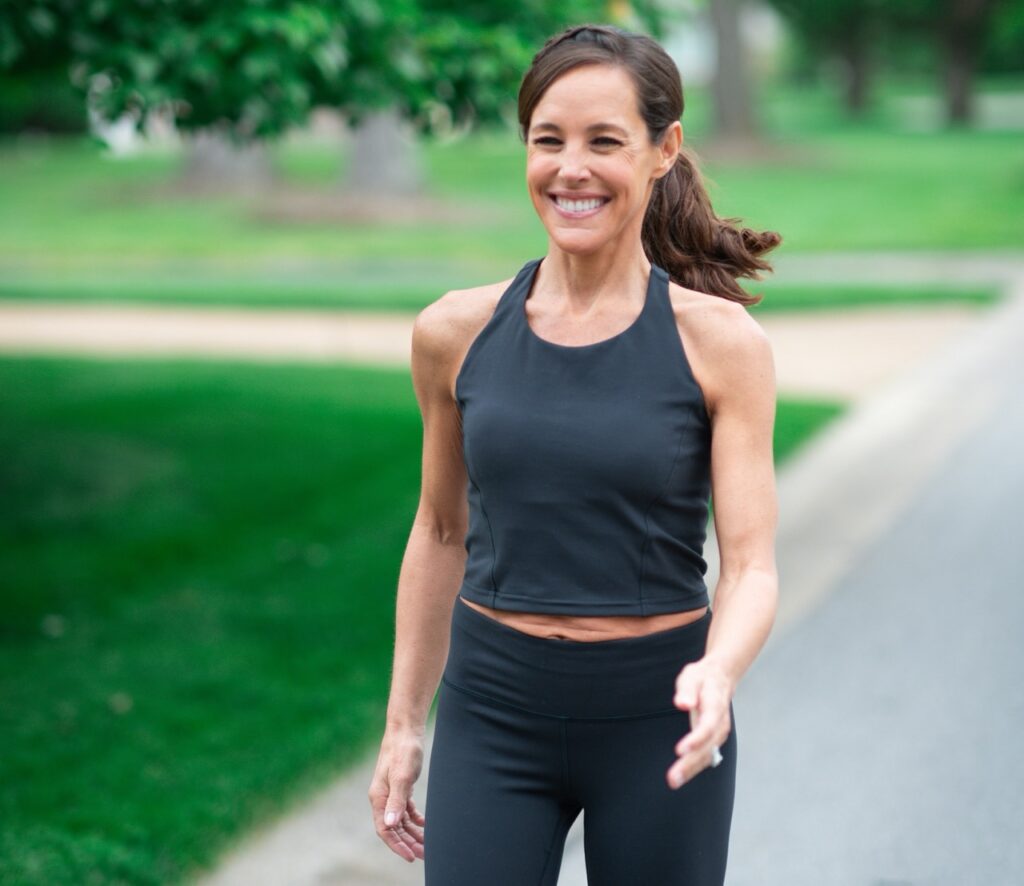 46 year old woman walking outdoors in zone 2 cardio for less inflammation and fat loss during perimenopause